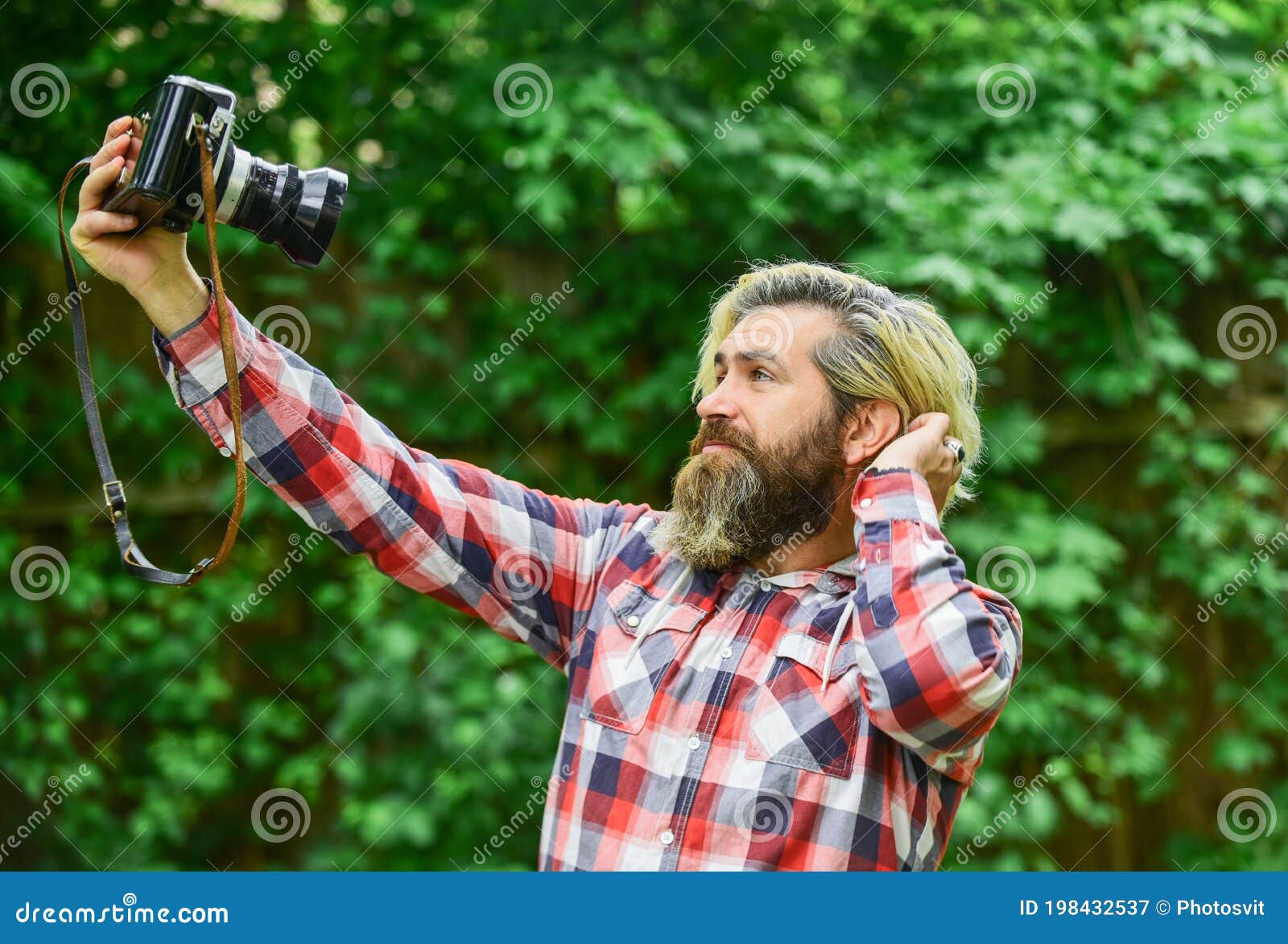 selfie time. vintage camera. capture these memories. slr camera. hipster man with beard use professional camera