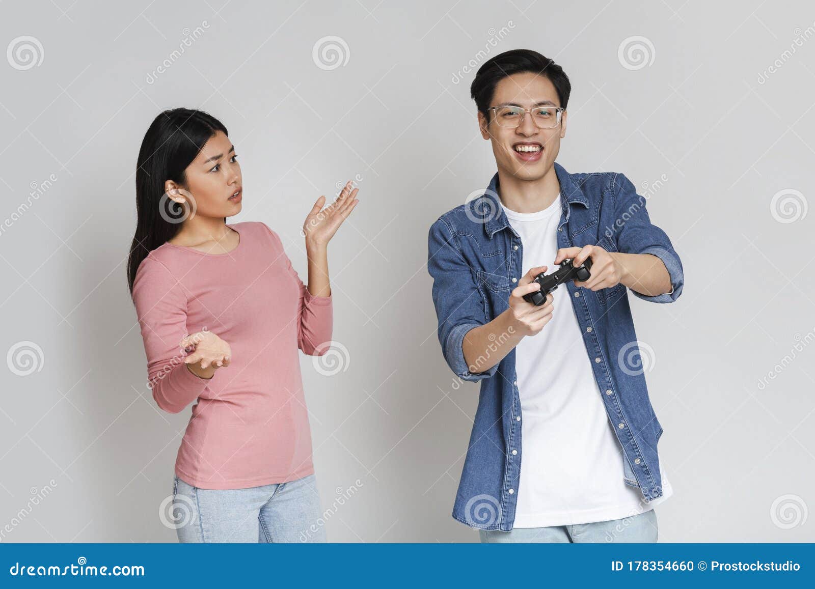 Man Playing Video Games At Home And His Girlfriend Bored Beside Looking At  Him Stock Photo, Picture and Royalty Free Image. Image 52407663.