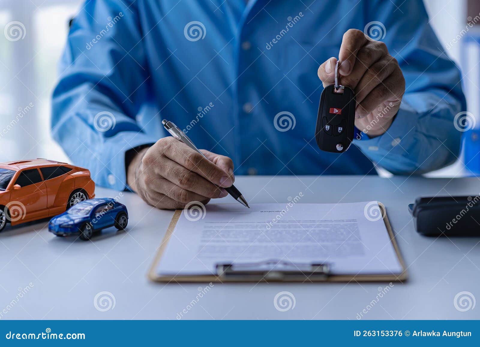 Selling A Car Management Concept The Dealer Gives The Car Keys To The selling-a-car-management-concept-the-dealer-gives-the-car-keys-to-the