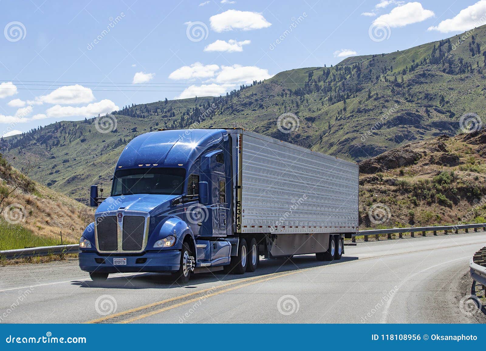 semi truck with trailer driving on highway
