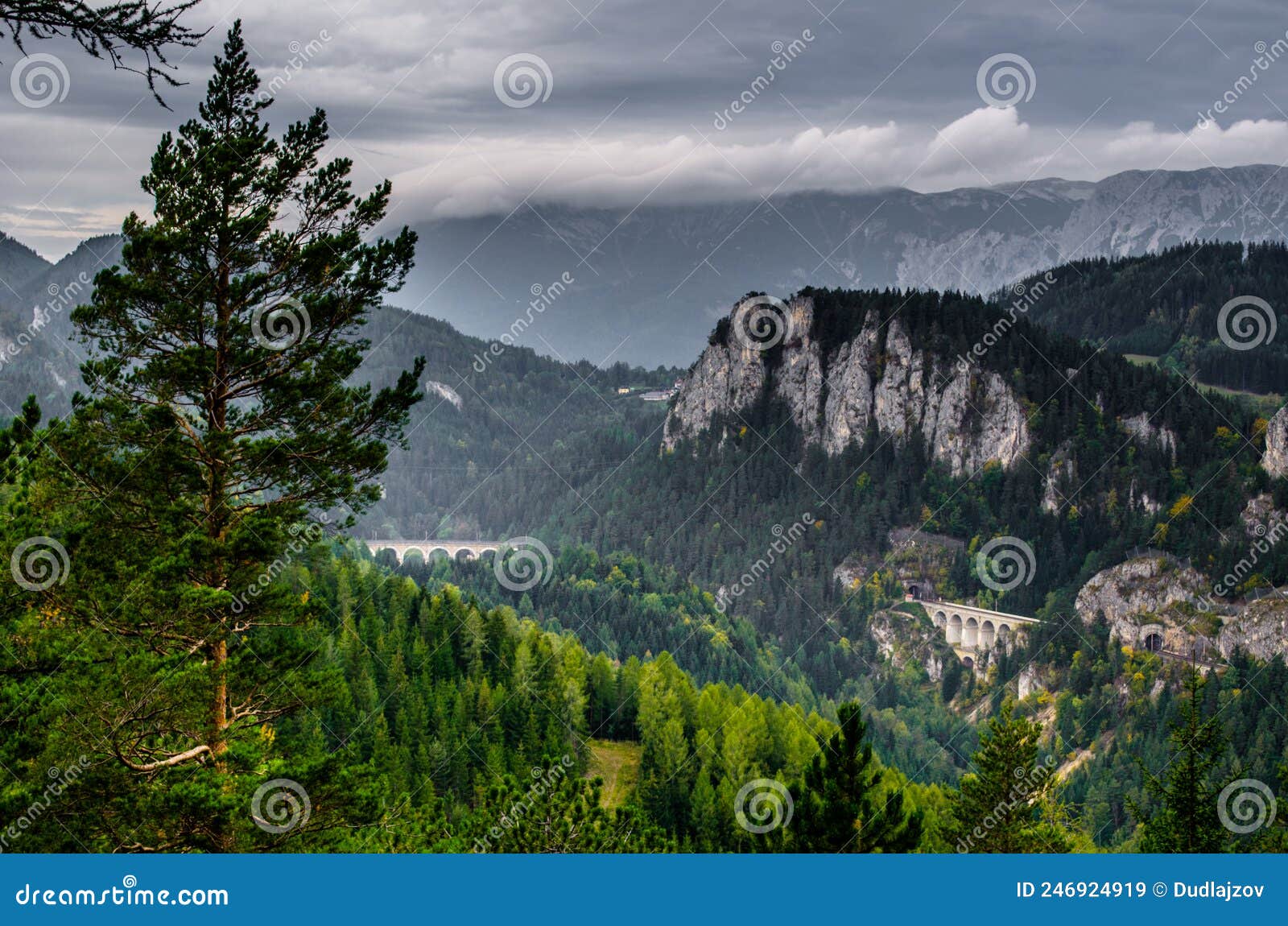 semmering railway with surrounding mountain scenery, krauselklause viaduct in front of polleroswand. in the background