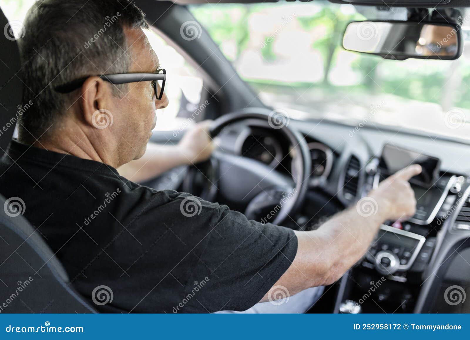 Senior Behind the Steering Wheel Using Gps Navigation Stock Photo