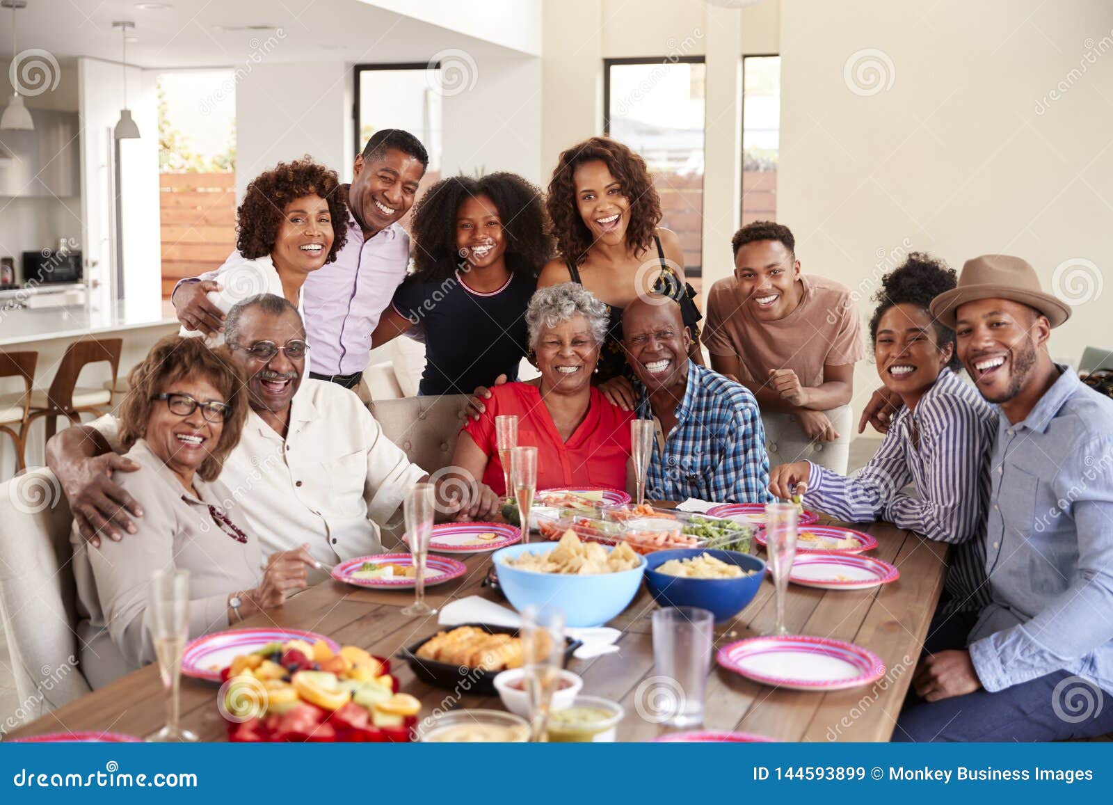 senior african american  couples sitting at dinner table celebrating at home with family,selective focus