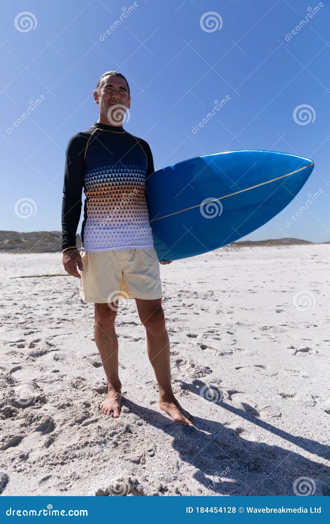 Senior Caucasian Man Holding a Surfboard at the Beach. Stock Photo ...