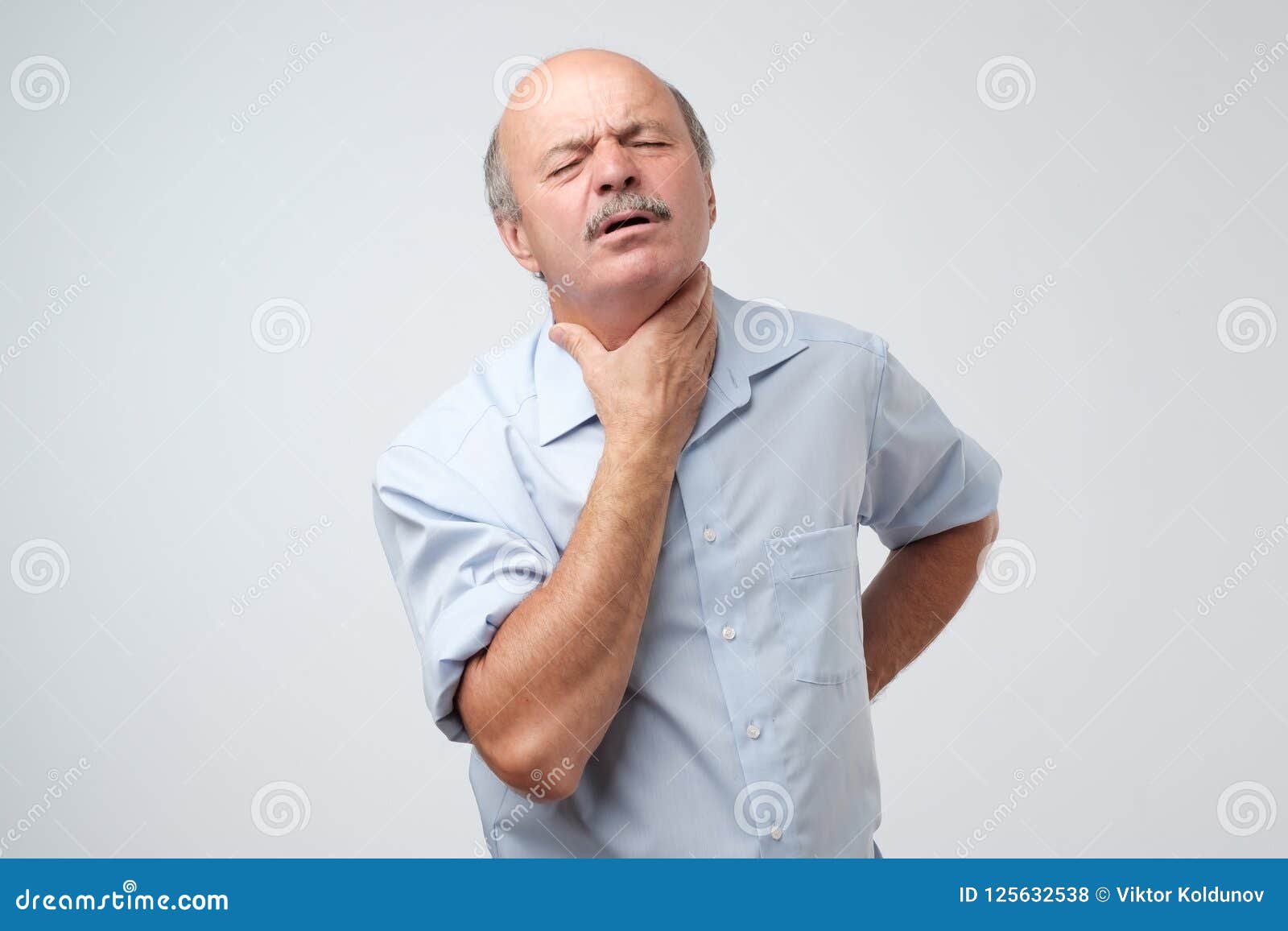 senior caucasian man in shirt having pain in throat. flu or other illness in cold winter.