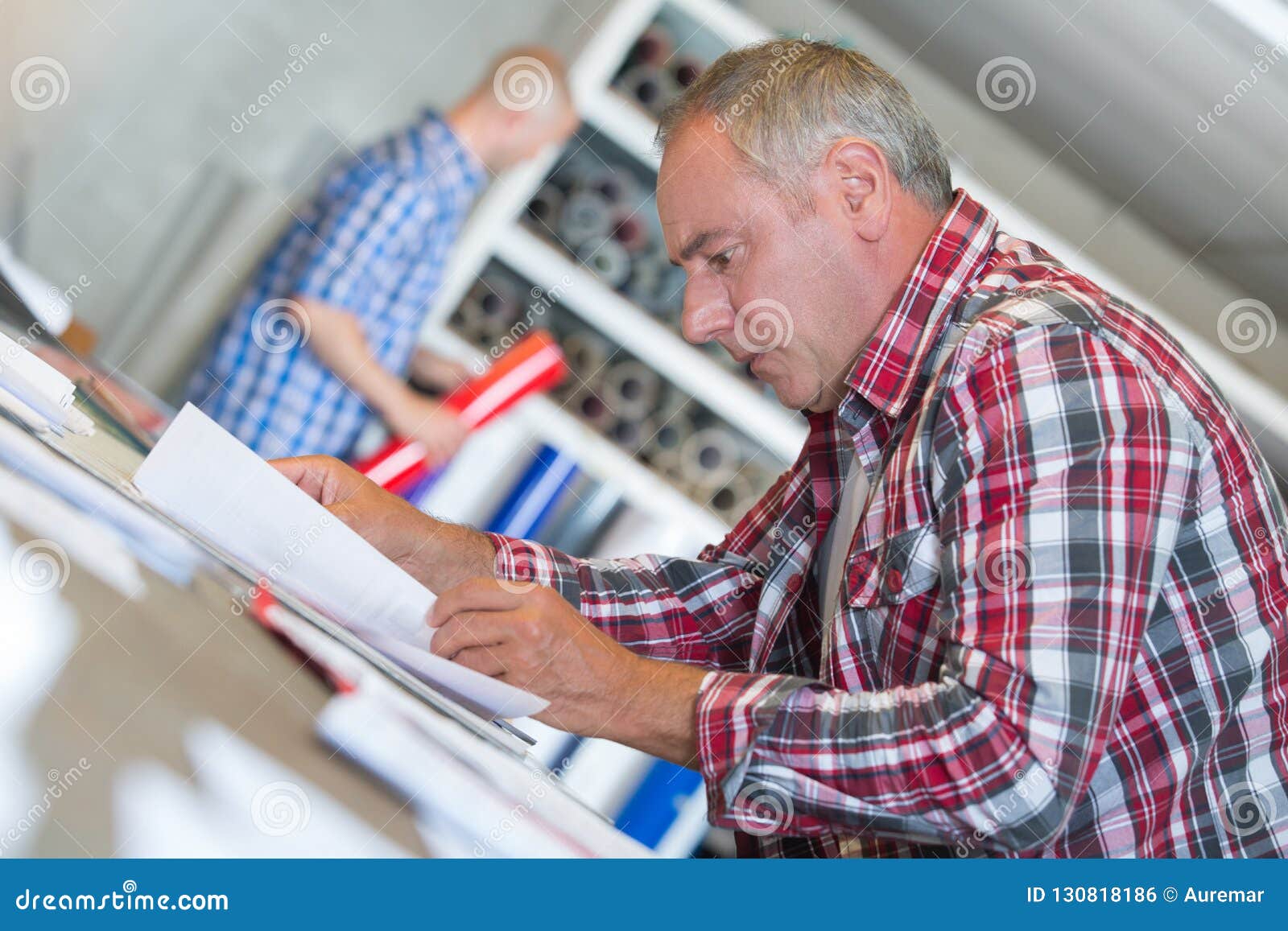 senior contractor at desk doing paperwork