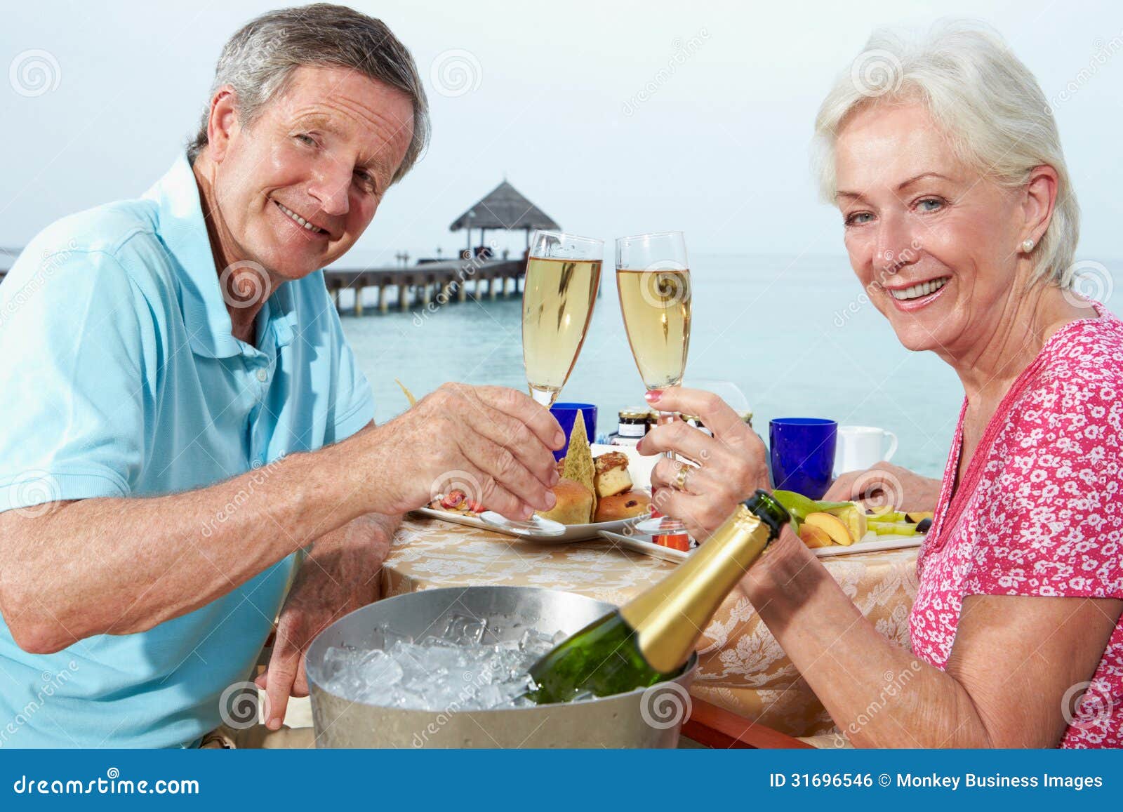 senior couple enjoying meal in seafront restaurant