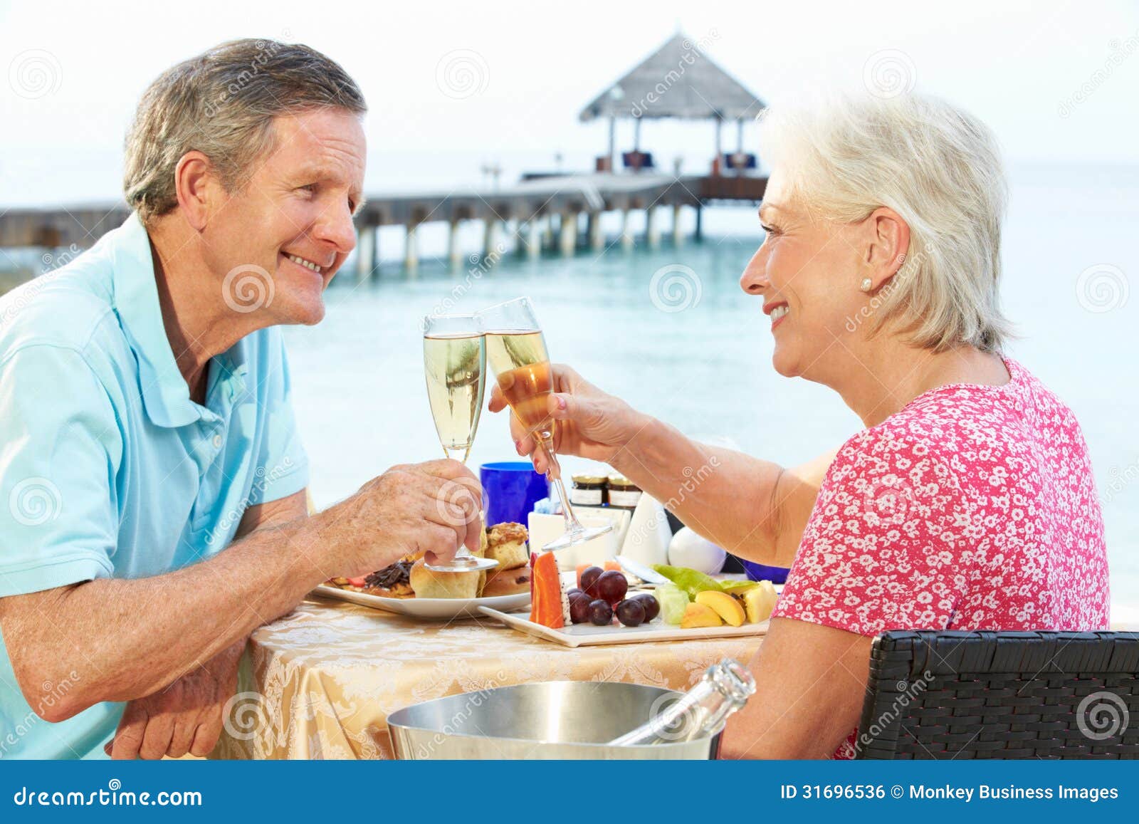 senior couple enjoying meal in seafront restaurant