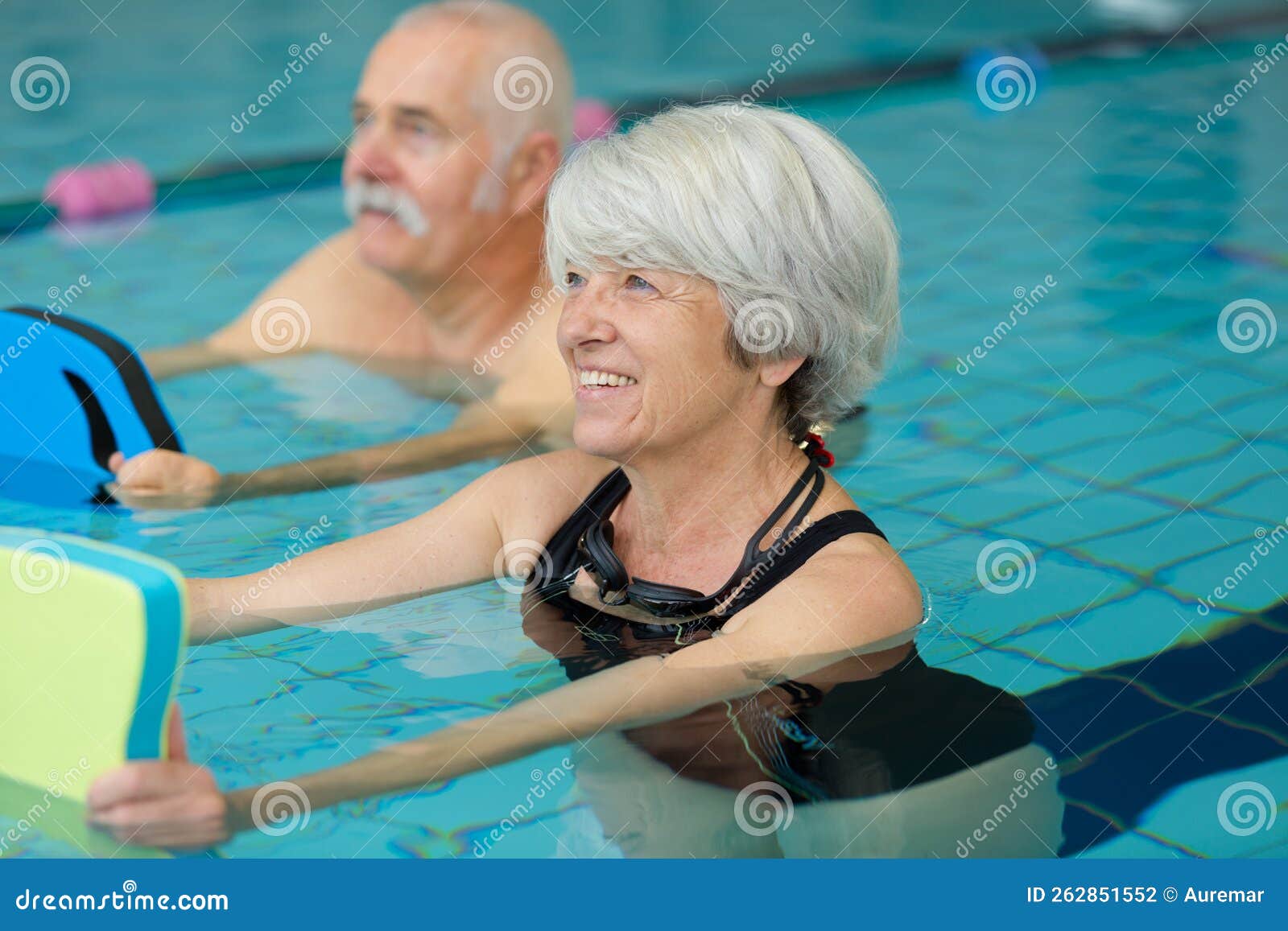 senior couple exercising in swimming pool