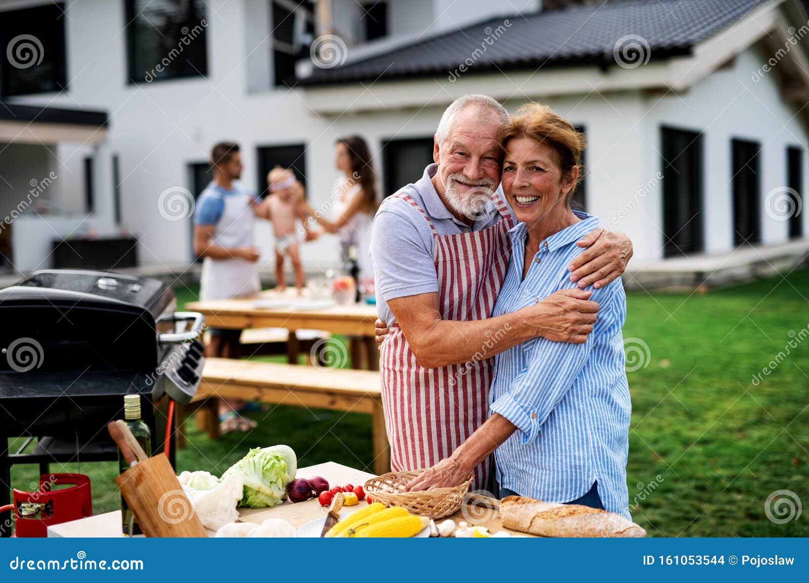 Senior Couple with Family Outdoors on Garden Barbecue, Grilling. Stock ...