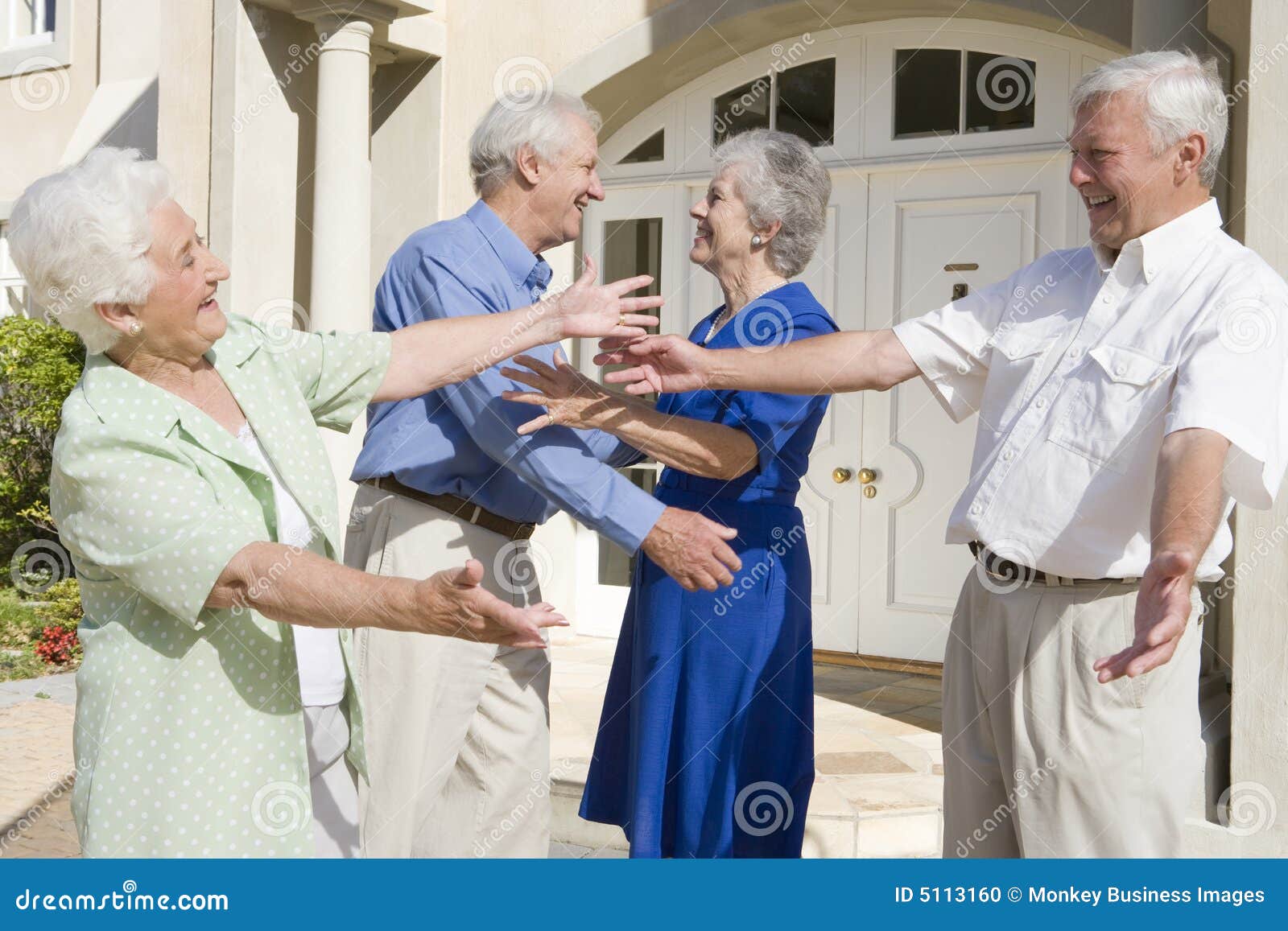 senior couple greeting friends