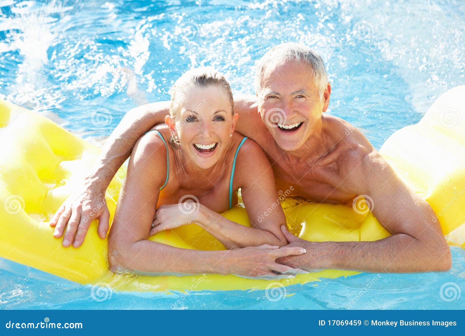 senior couple having fun in pool