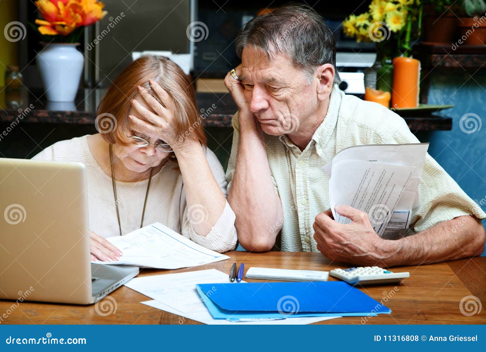 senior couple at home with many bills