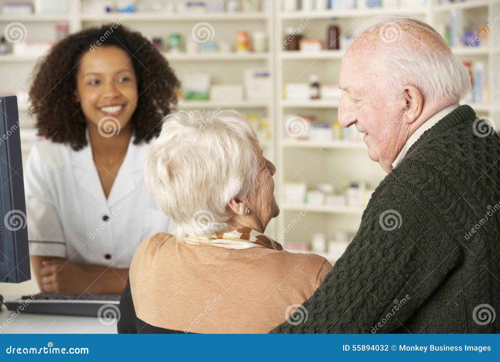 senior couple in pharmacy with pharmacist