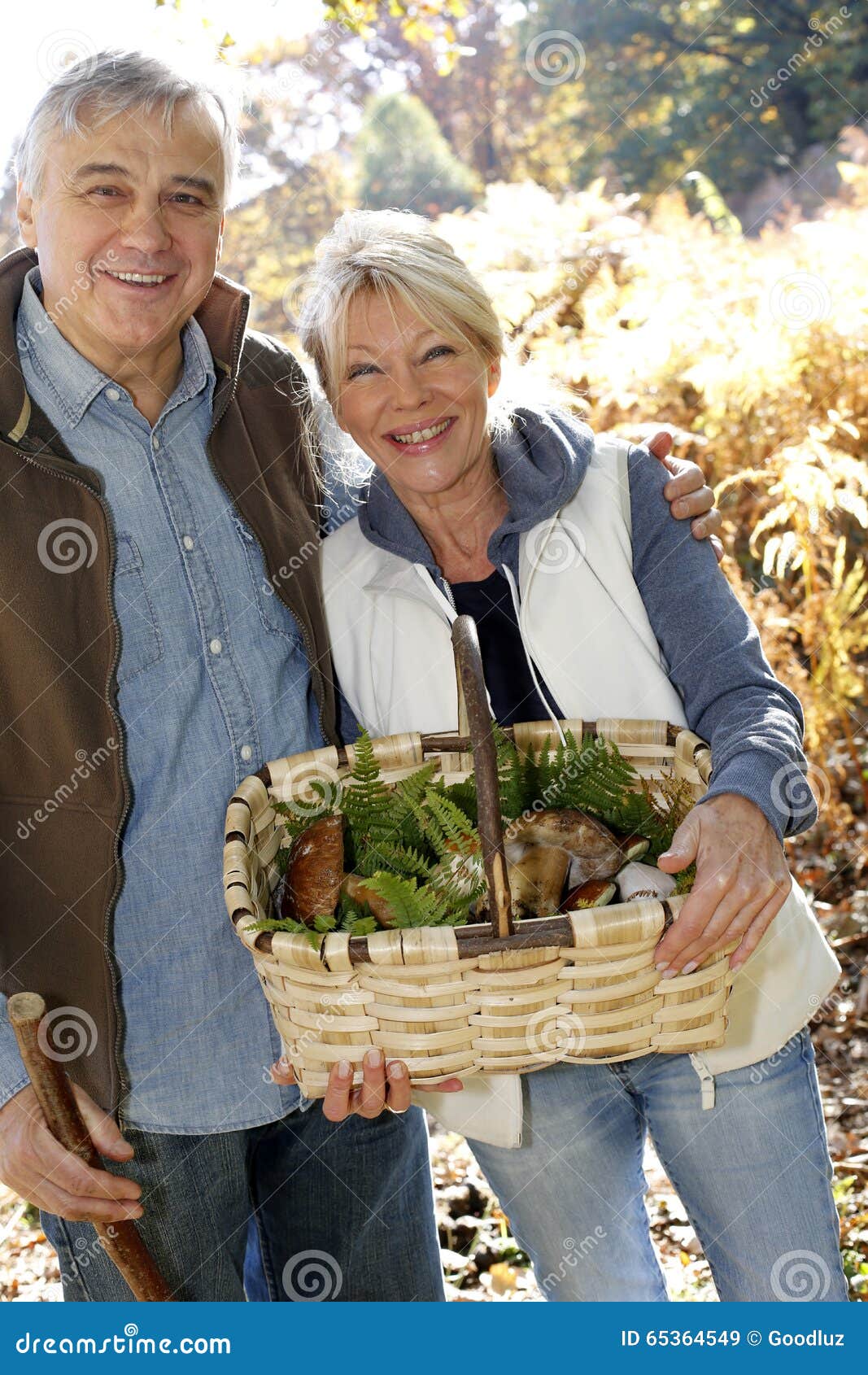 senior couple picking with basket of ceps