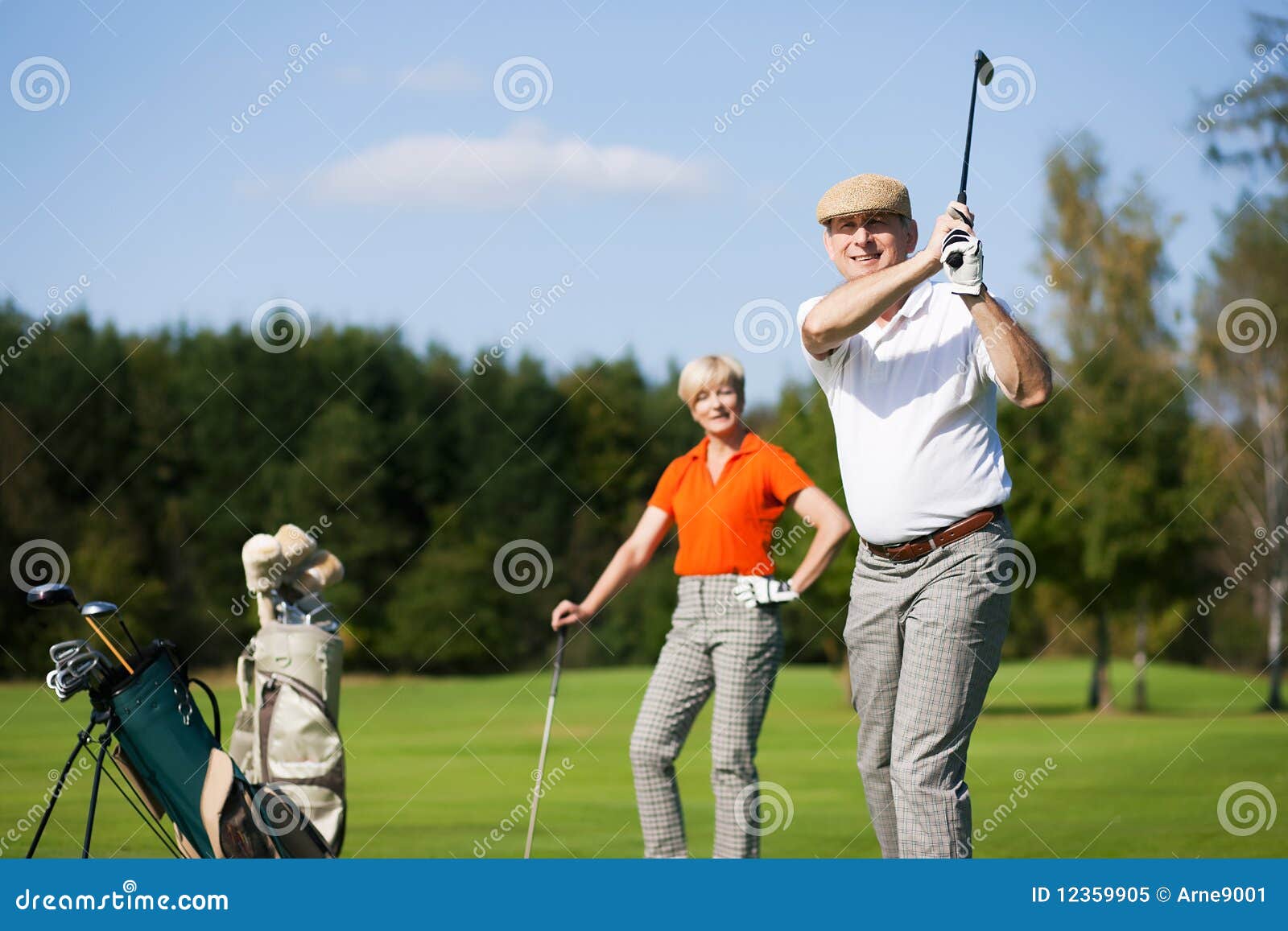 Senior couple playing Golf stock image. Image of recreation 12359905