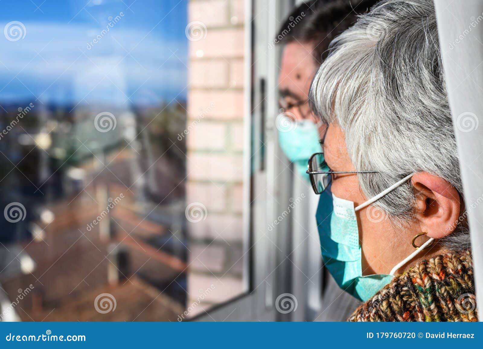 Senior Couple, with Protective Face Masks, at Home Looking through the ...