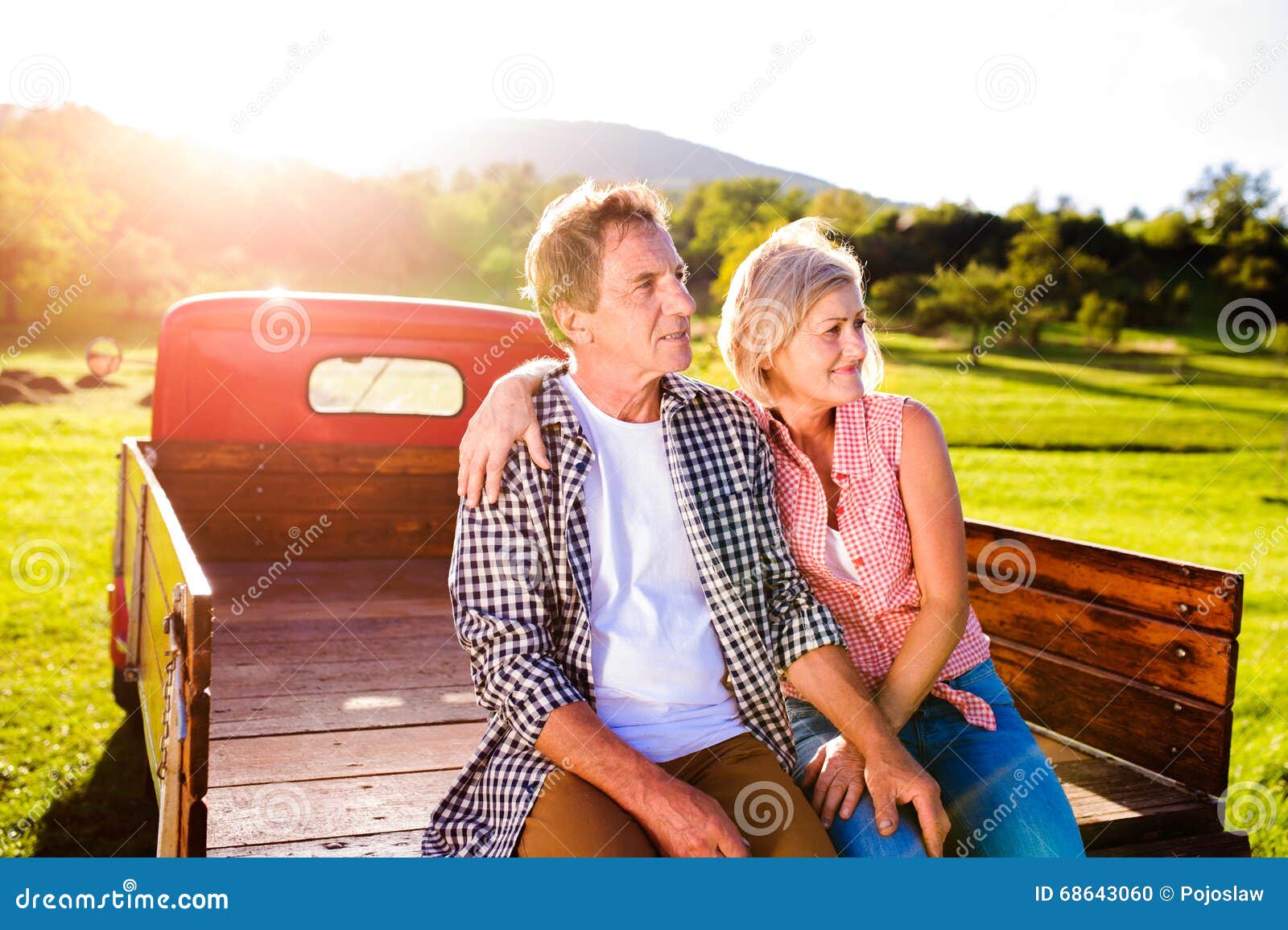 Senior Couple Sitting in Back of Red Pickup Truck Stock Photo - Image ...