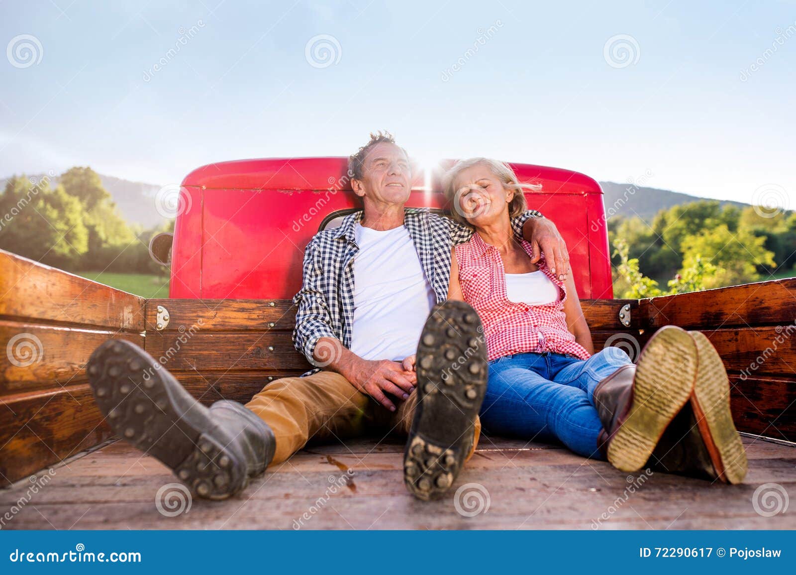 Senior Couple Sitting in Back of Red Pickup Truck Stock Image - Image ...