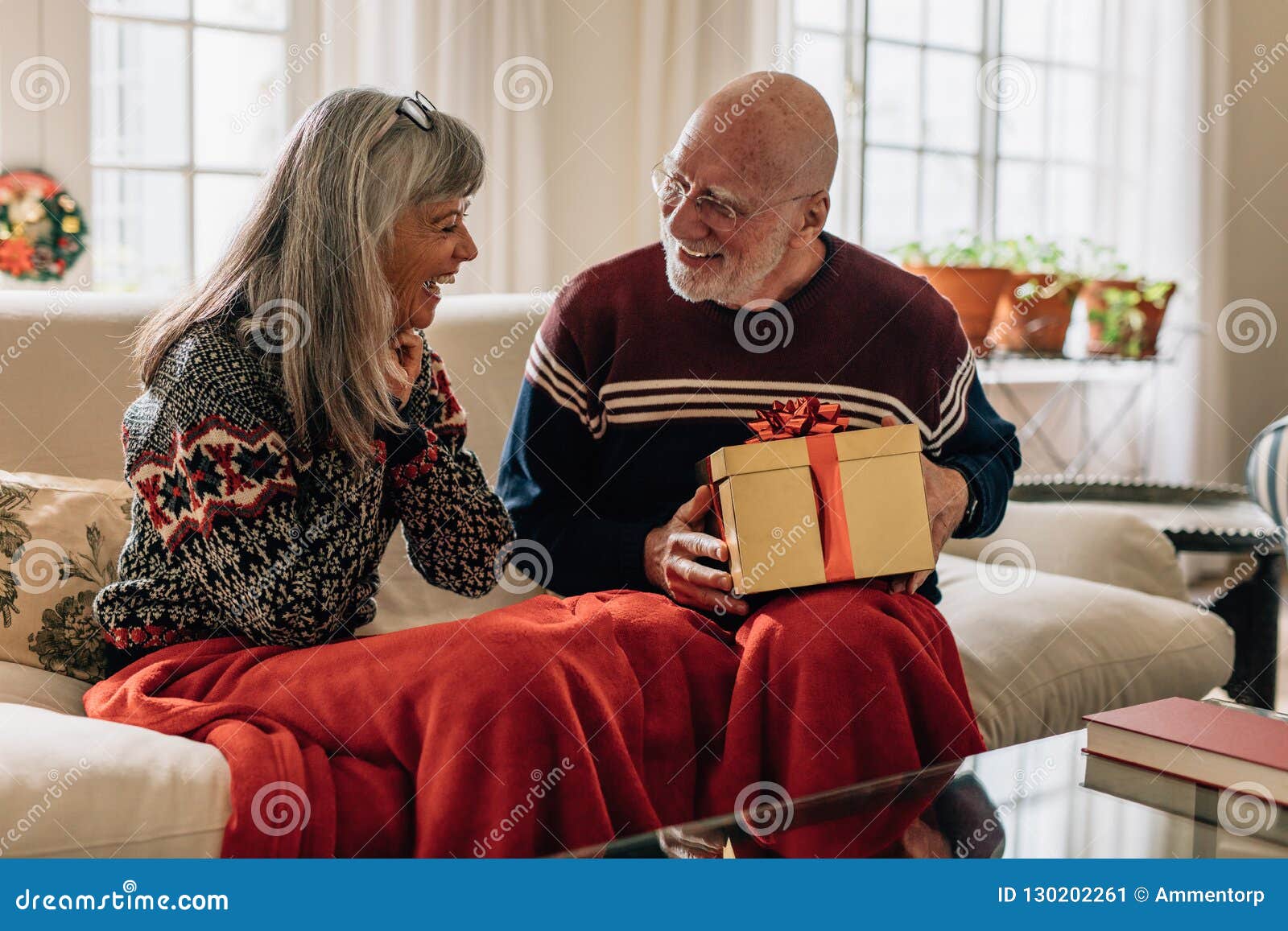 Senior Couple Sitting At Home With A Christmas Present Stock Image Image Of Present Affection