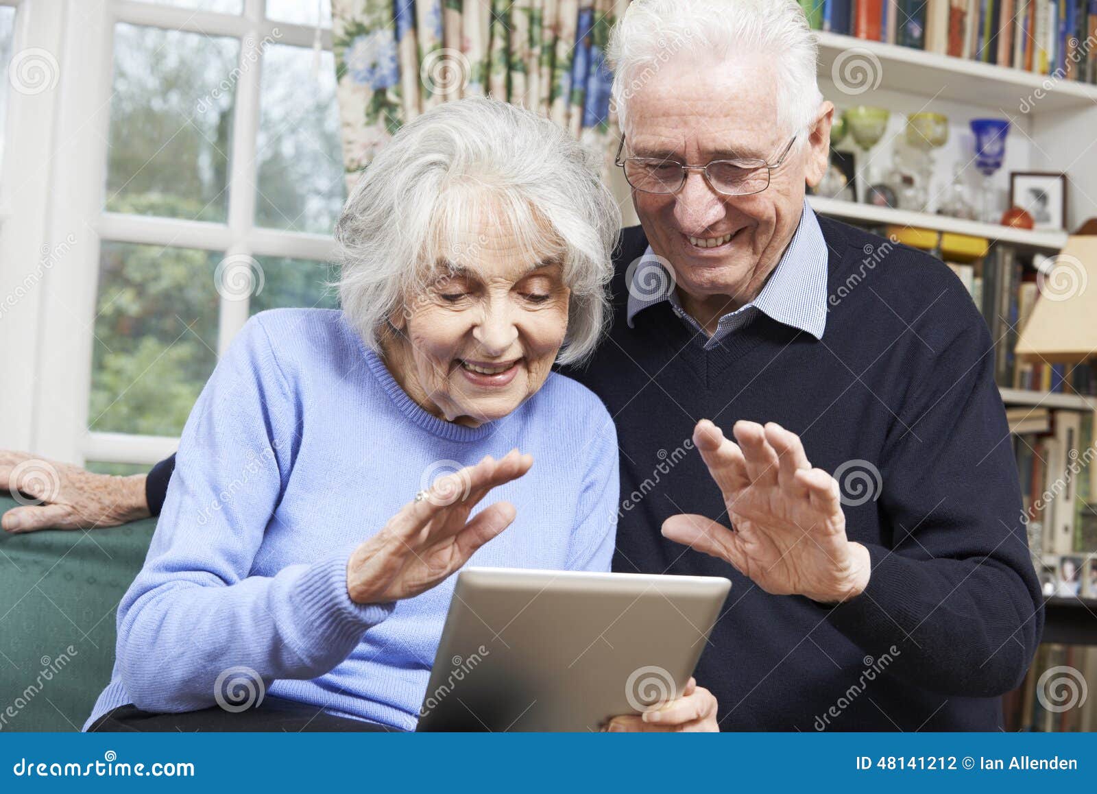 Senior Couple Using Digital Tablet for Video Call with Family Stock
