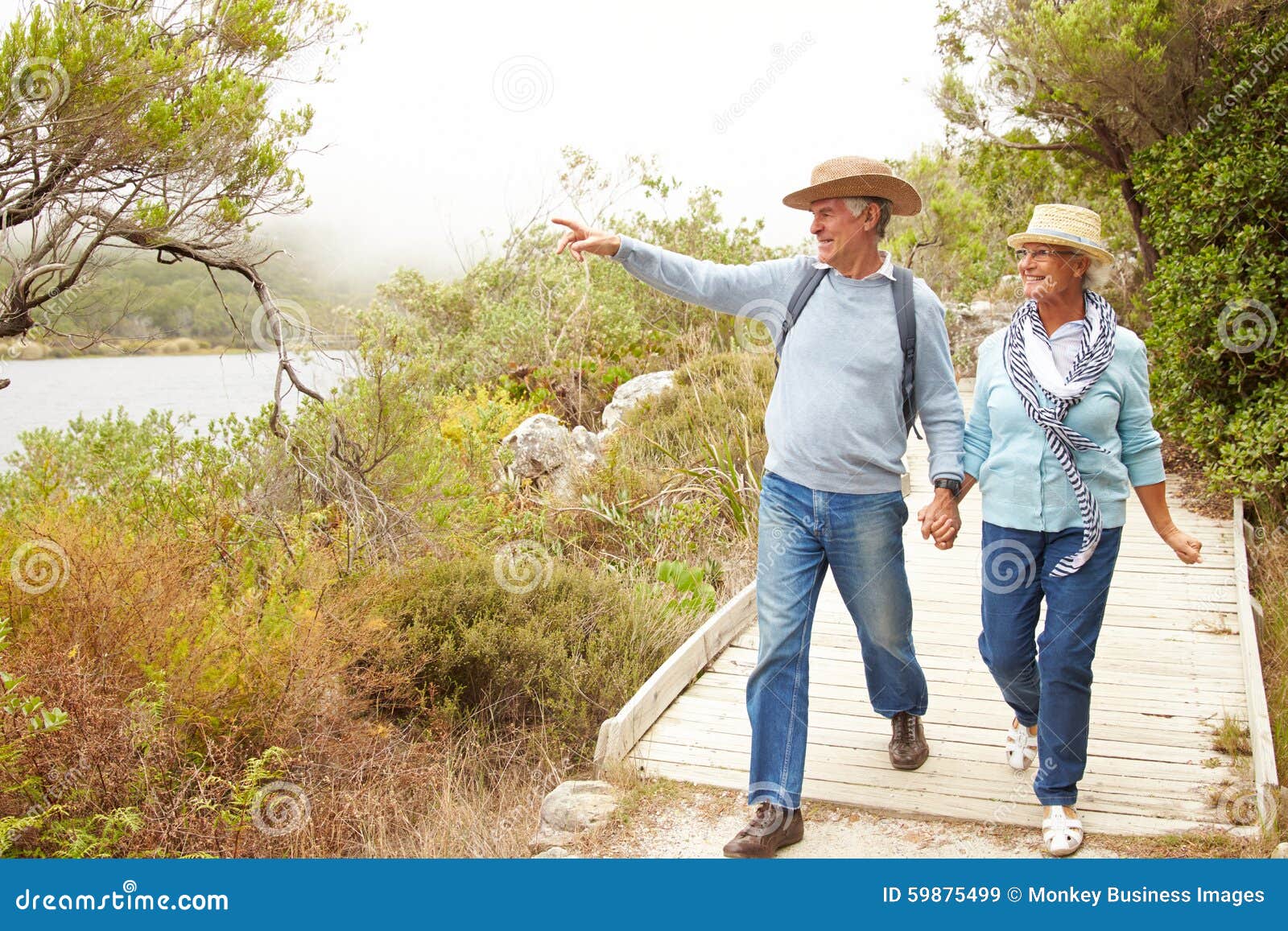 Senior Couple Walking Together by a Lake Stock Image Image of adults