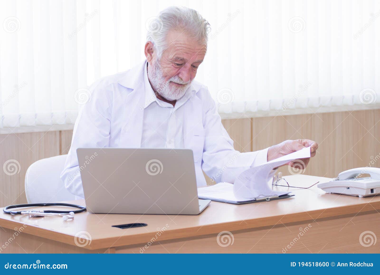 Senior Doctor Sitting on Working Desk Stock Photo - Image of laptop ...