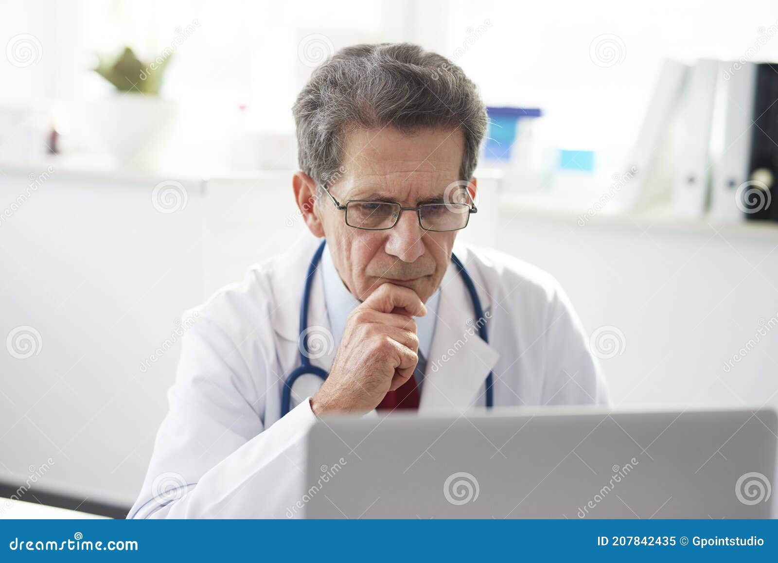 senior doctor working with a laptop in doctorÃ¢â¬â¢s office