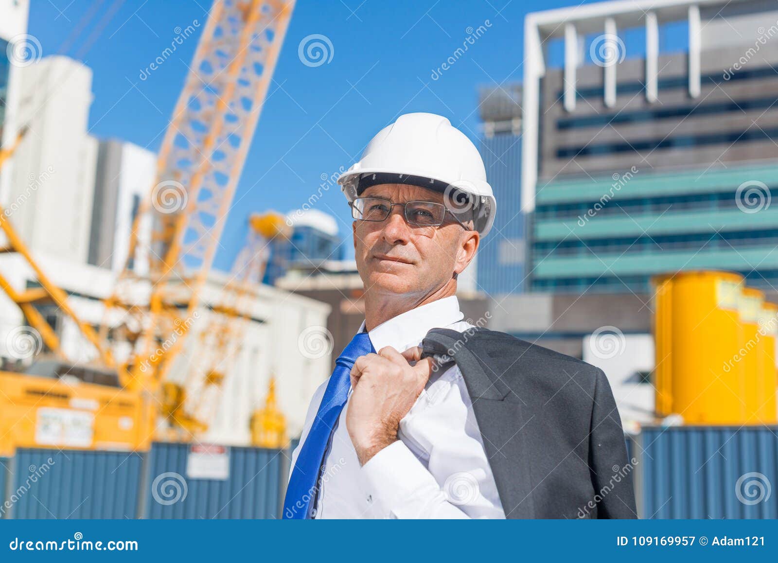 Senior Elegant Builder Man in Suit at Construction Site on Sunny Summer