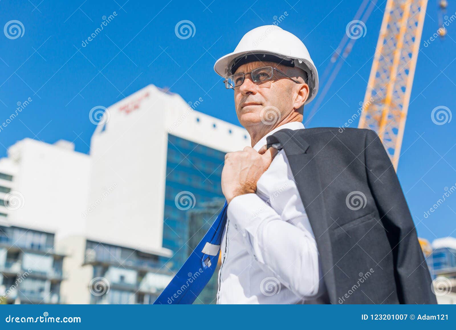 Senior Elegant Builder Man in Suit at Construction Site on Sunny Summer