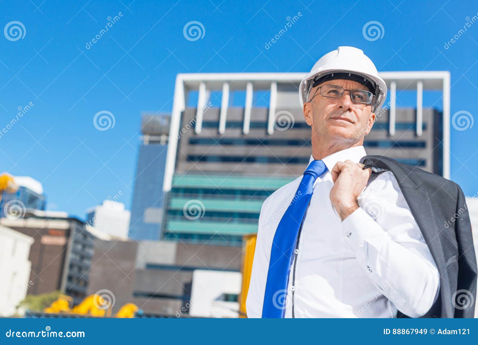Senior Elegant Builder Man in Suit at Construction Site on Sunny Summer