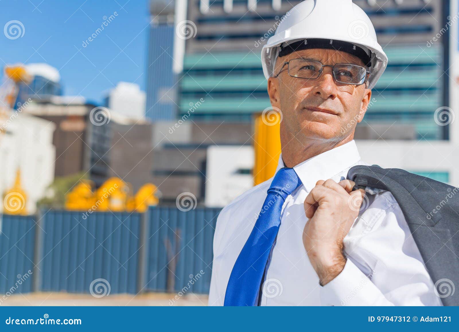 Senior Elegant Builder Man in Suit at Construction Site on Sunny Summer