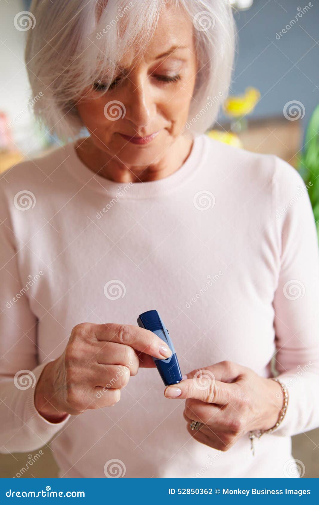 senior female diabetic checking blood sugar levels