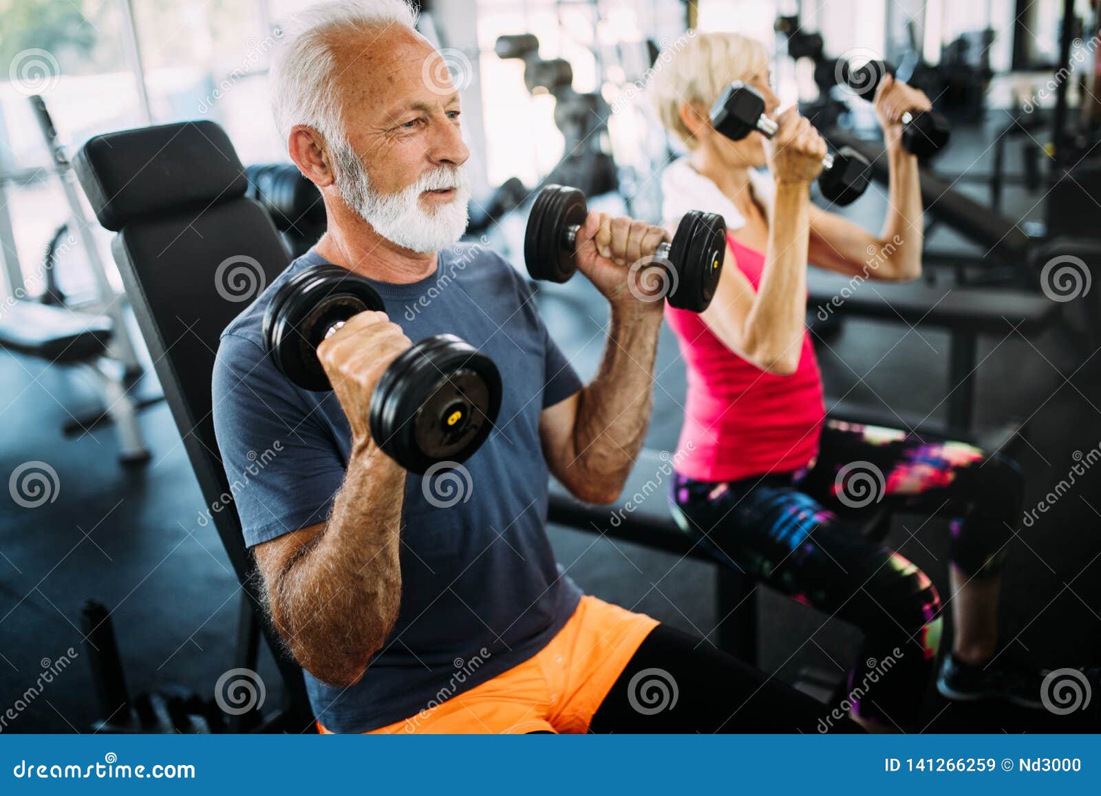 Senior Fit Man and Woman Doing Exercises in Gym To Stay Healthy Stock ...