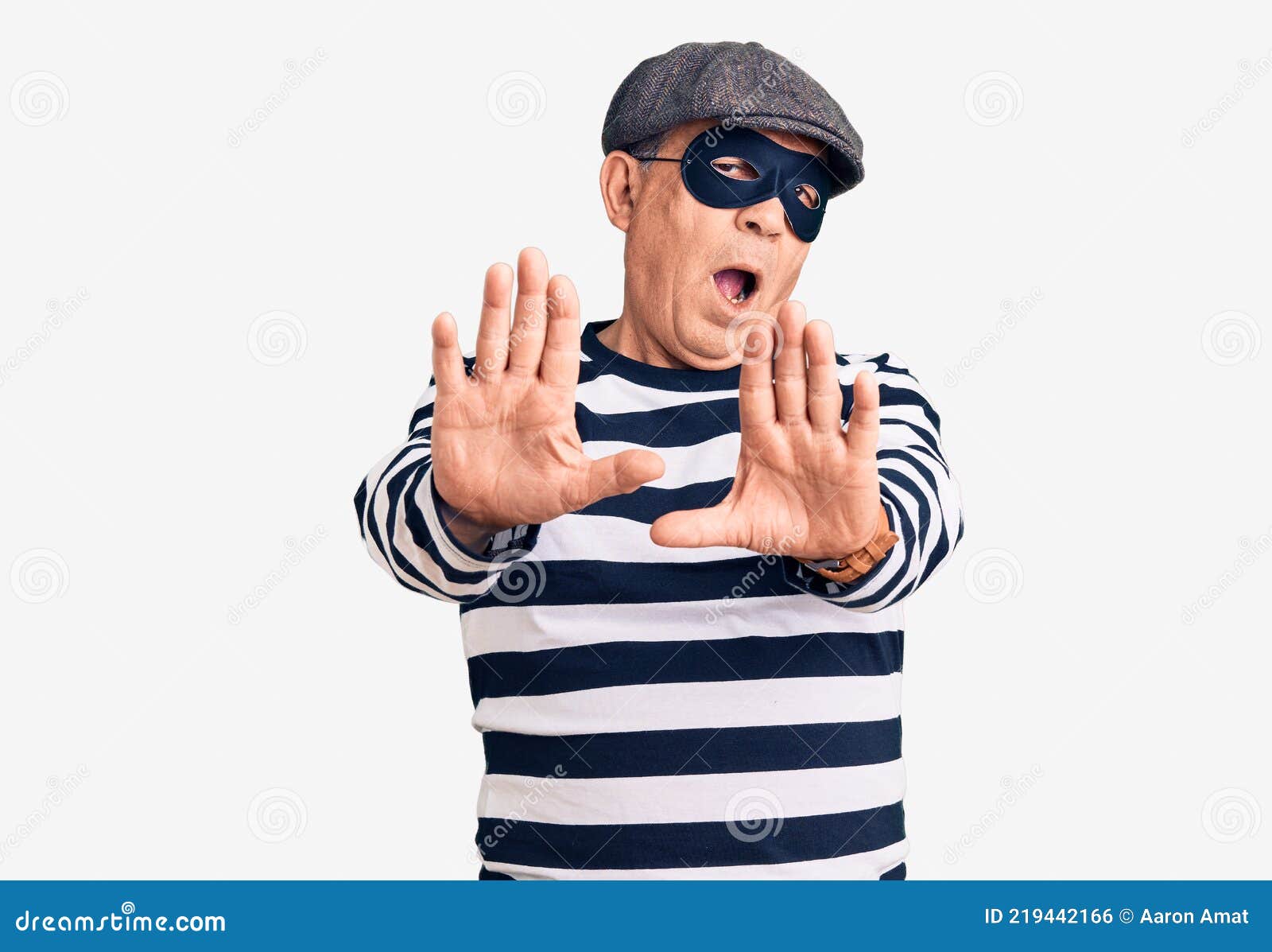 Senior Handsome Man Wearing Burglar Mask And T Shirt Doing Stop Gesture With Hands Palms Angry