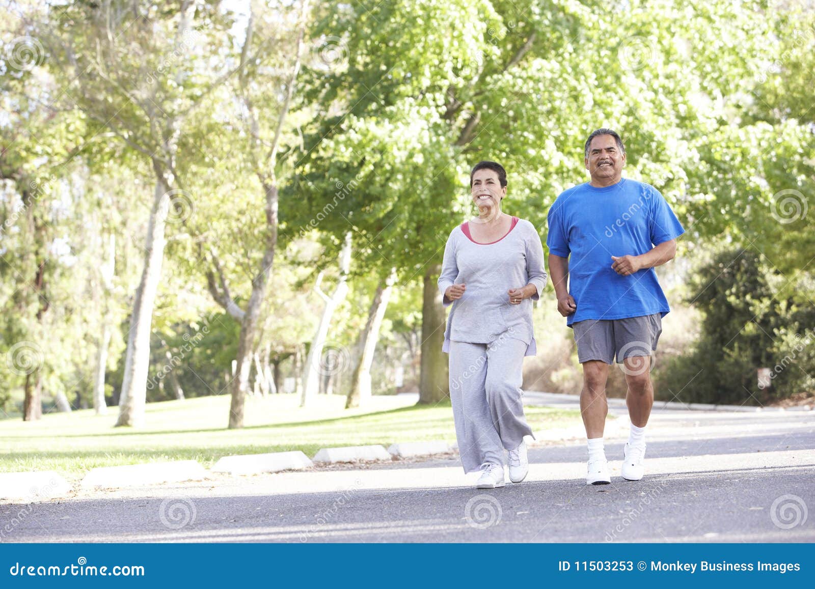 senior hispanic couple jogging in park