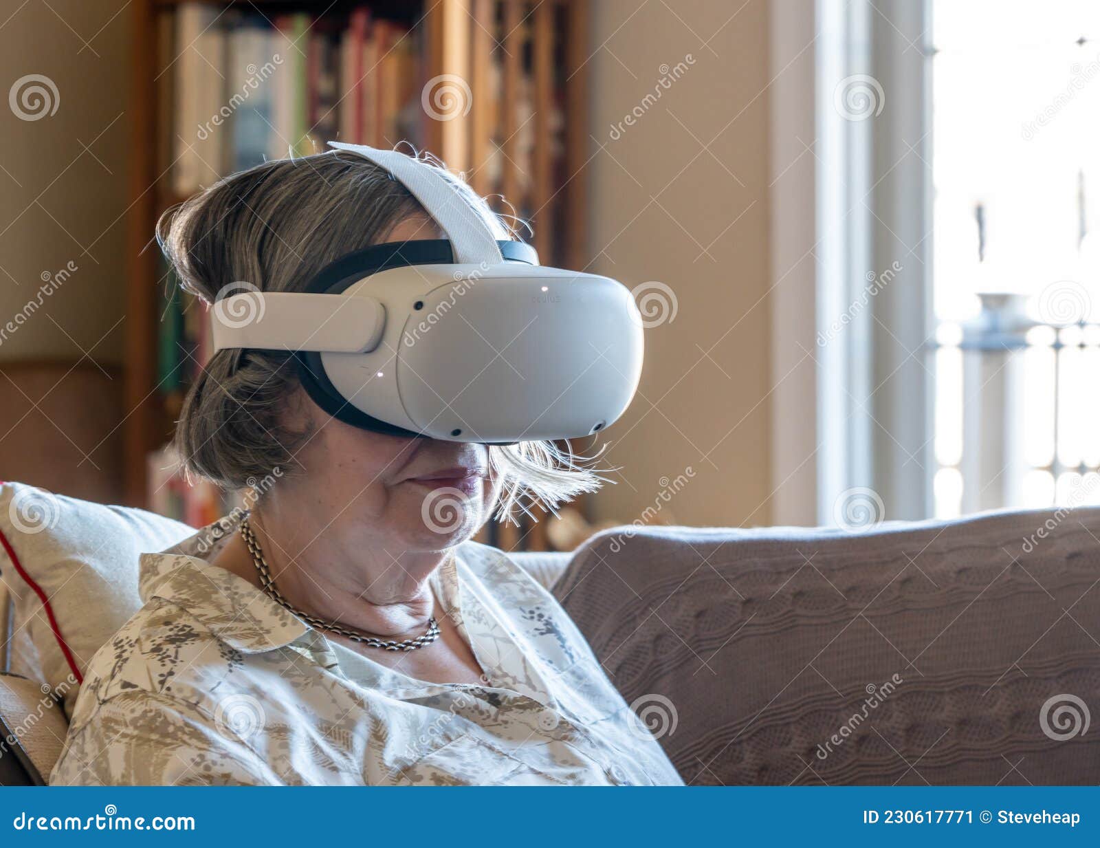 senior adult woman watching an app on a modern vr headset