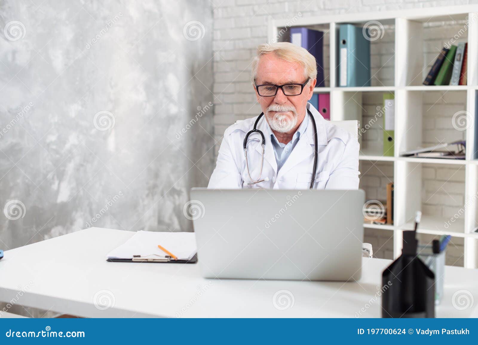 Senior Male Doctor with a Stethoscpe Using Laptop Stock Photo - Image ...