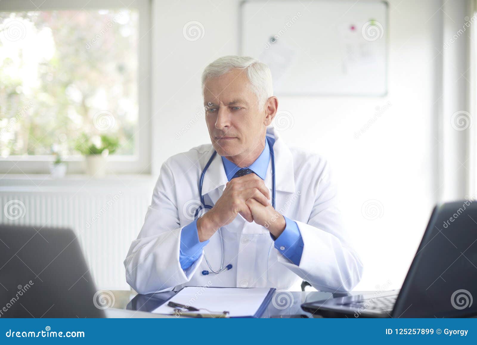 Senior Male Doctor Working at Consulting Room Stock Image - Image of ...