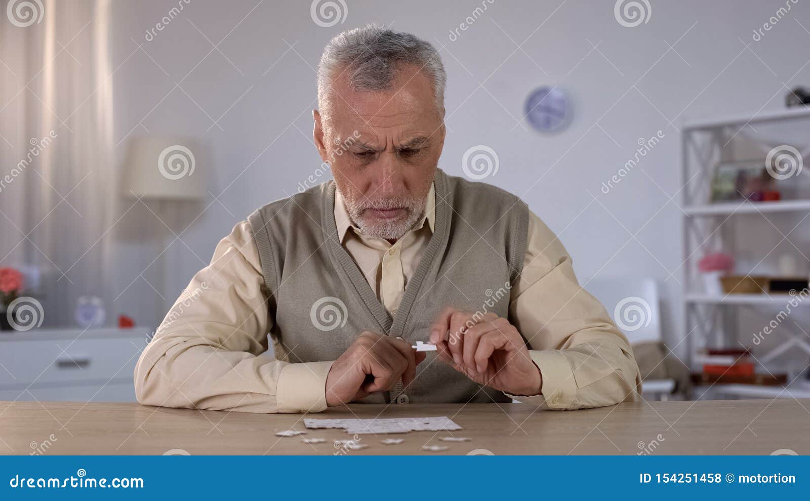 senior male trying to collect puzzle, memory problems, cognitive impairment