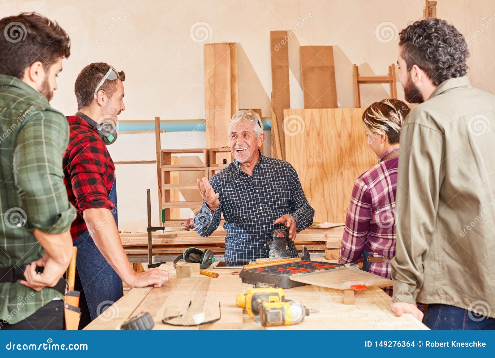 Craftsman Master With Apprentices At The Workbench Stock 