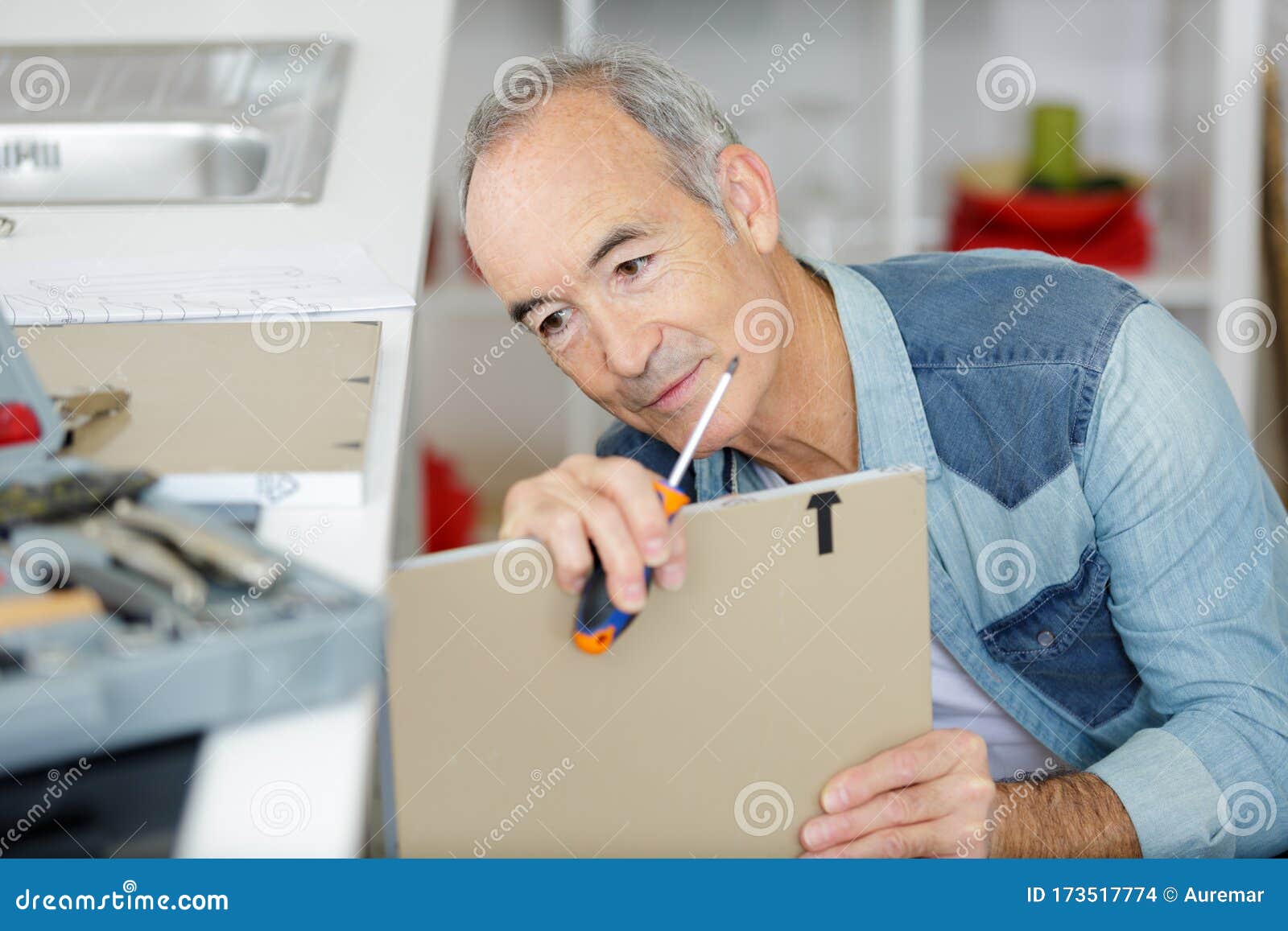 Senior Man Assembling Kitchen Cupboard Stock Photo Image of