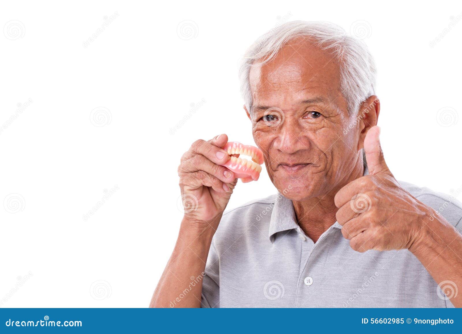 senior man with denture, giving thumb up