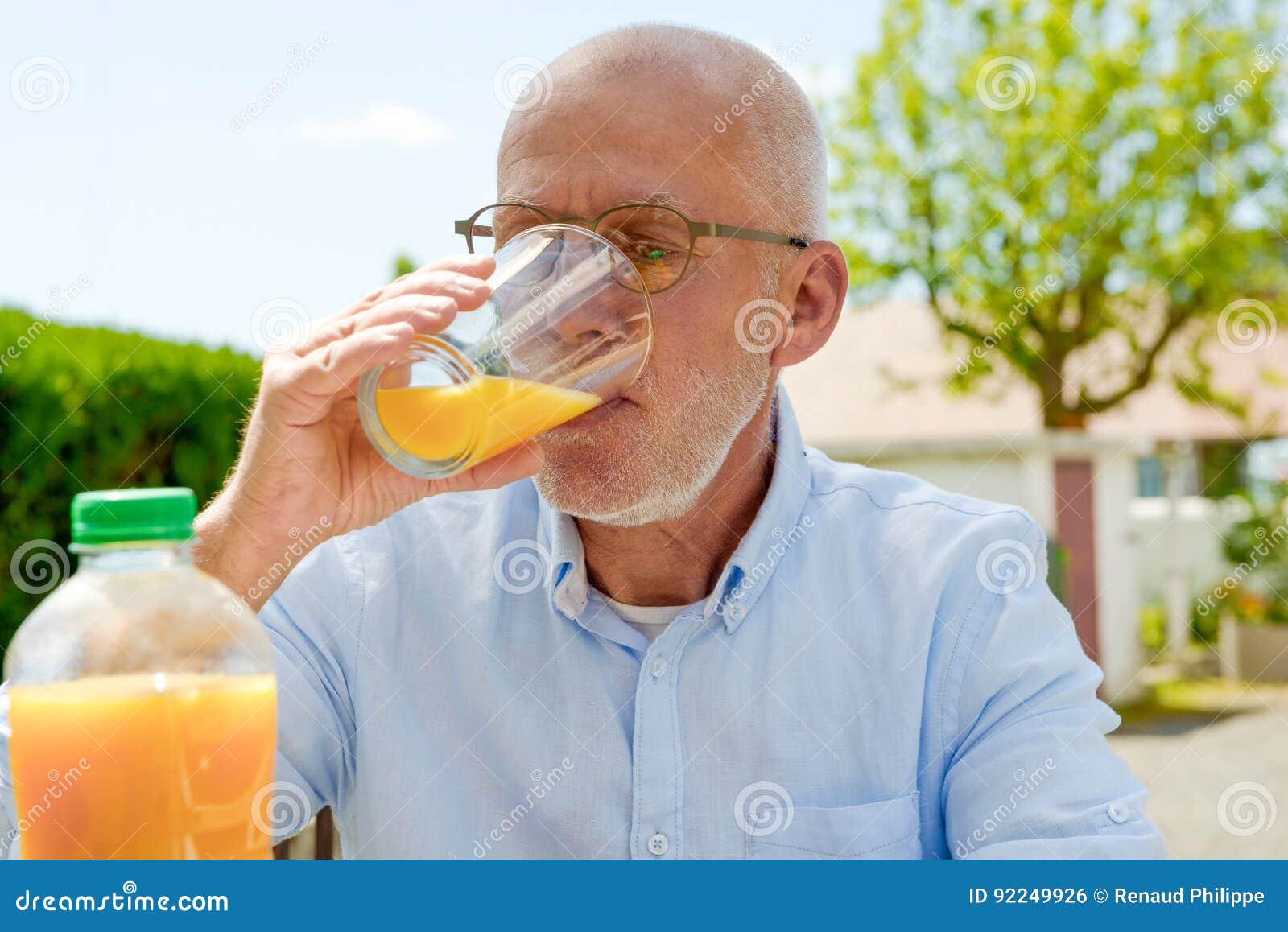 Senior Man Drinking Orange Juice in Her Garden Stock Photo - Image of ...