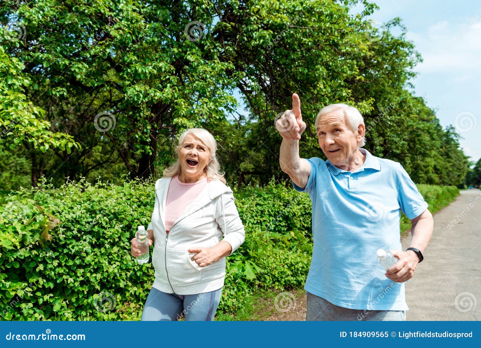 Senior Man Pointing With Finger Near Wife Holding Bottle In Park Stock Image Image Of Daylight