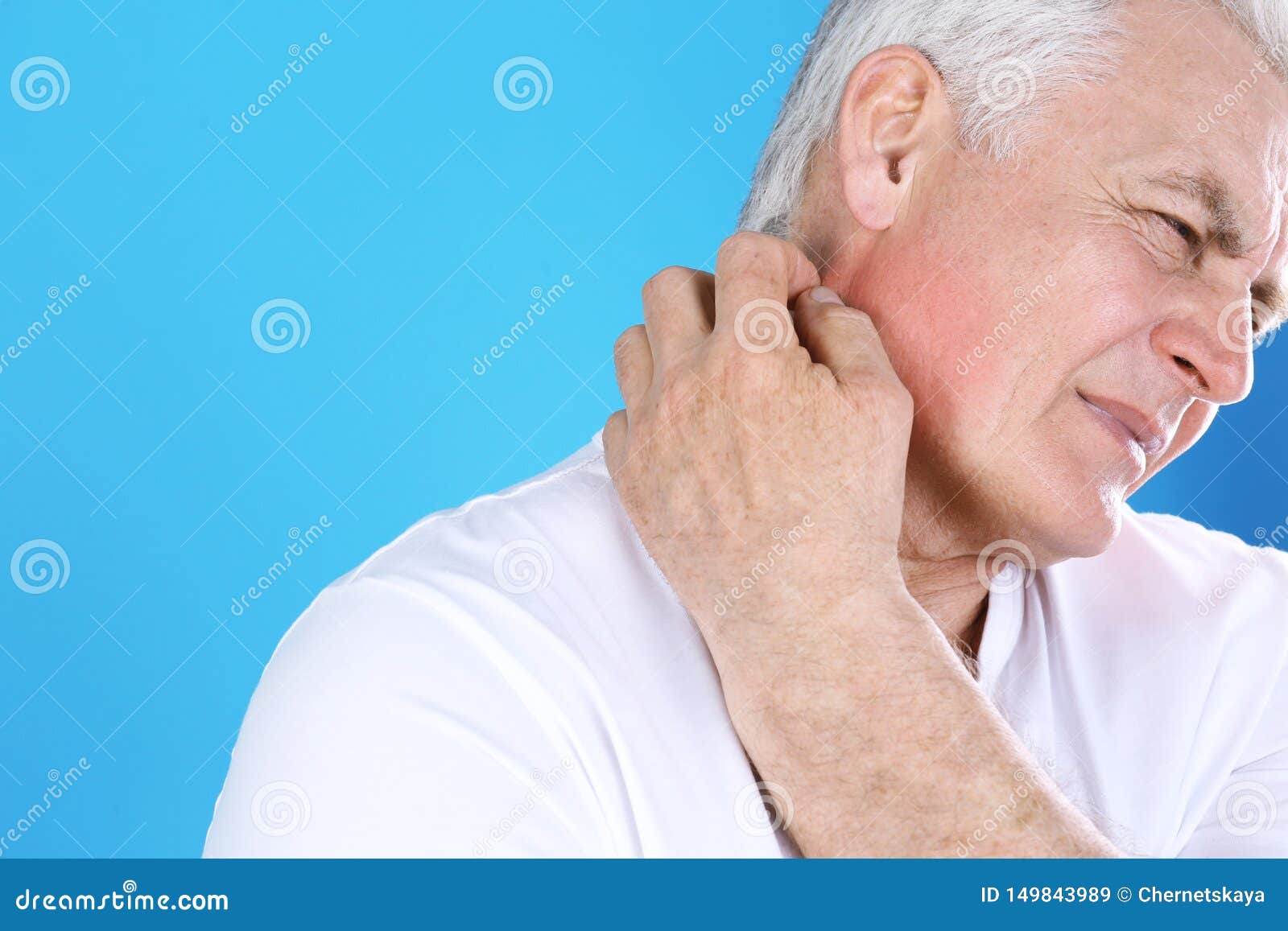 Senior Man Scratching Neck On Color Background Allergy Symptom Stock