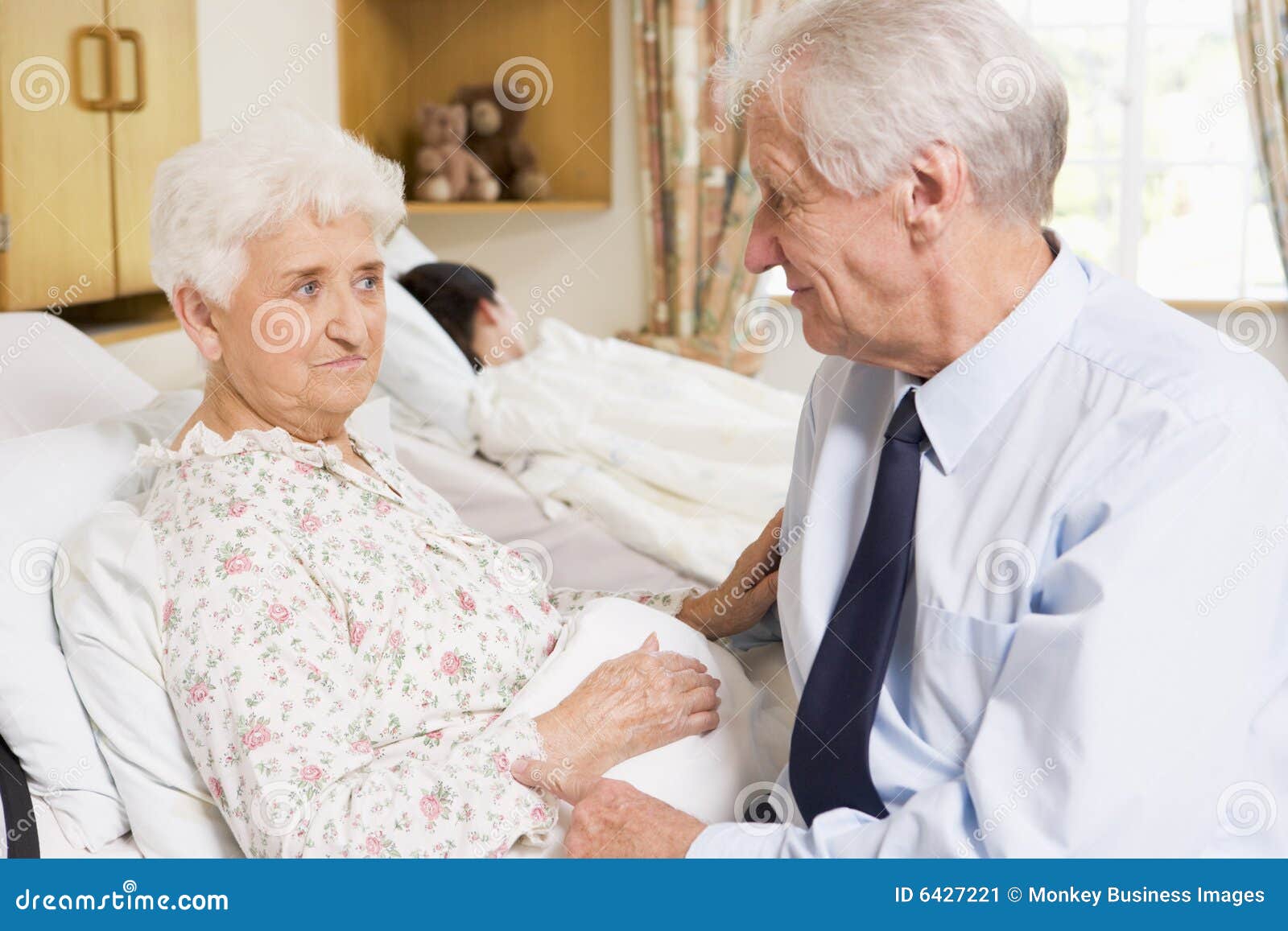 Senior Man Sitting with His Wife in Hospital Stock Image image