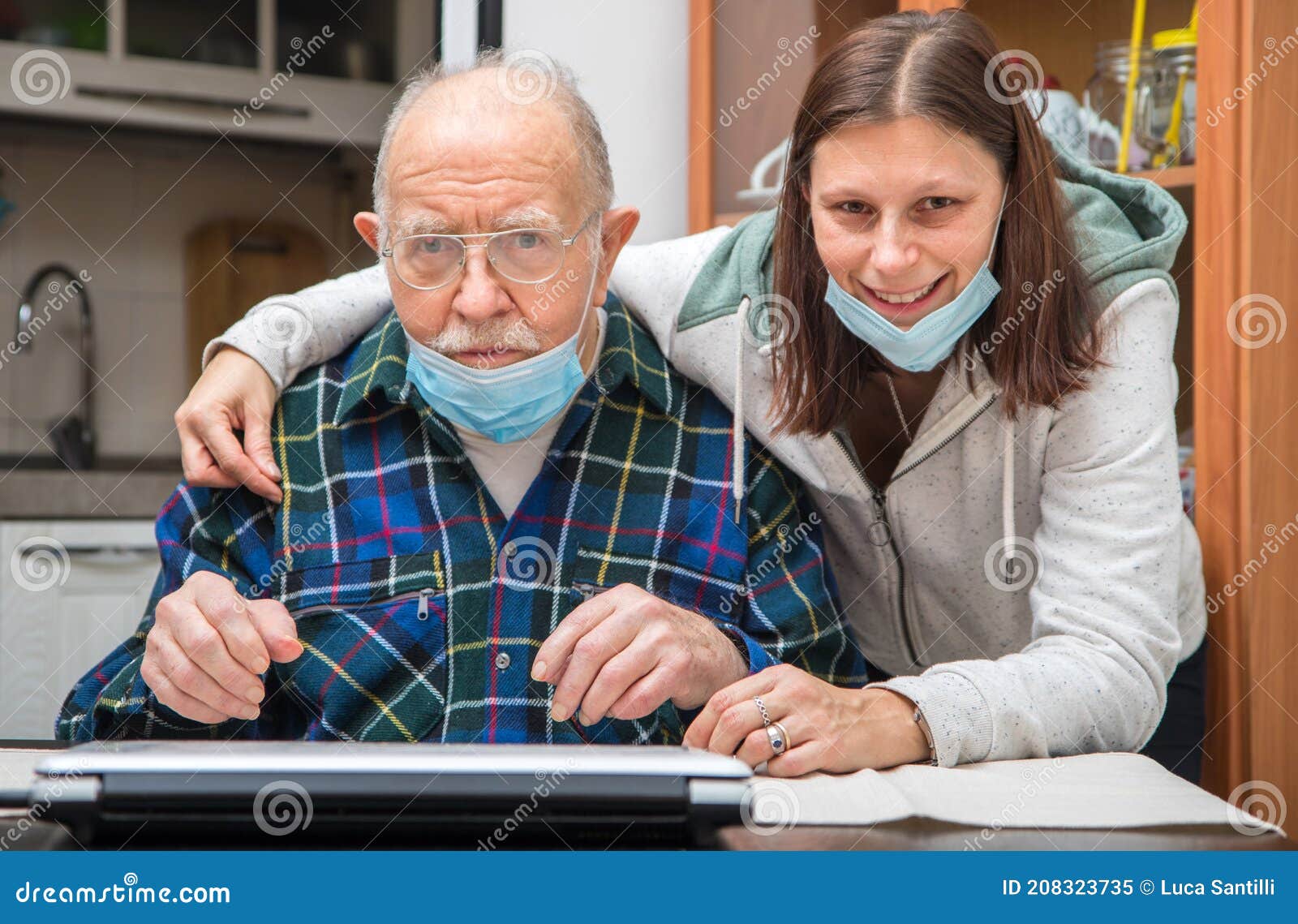 senior man with their caregiver at home during coronavirus pandemia