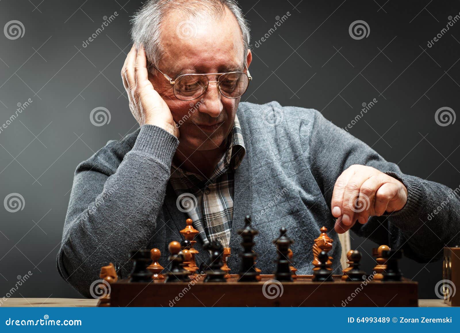 Senior man planning his next chess move, Stock image