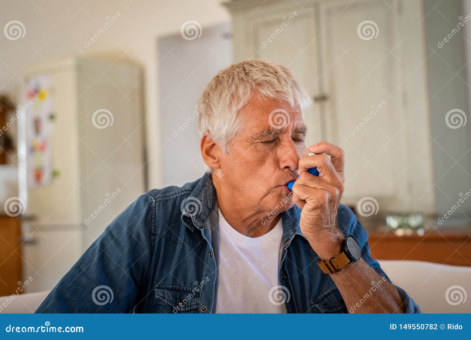senior man using asthma pump